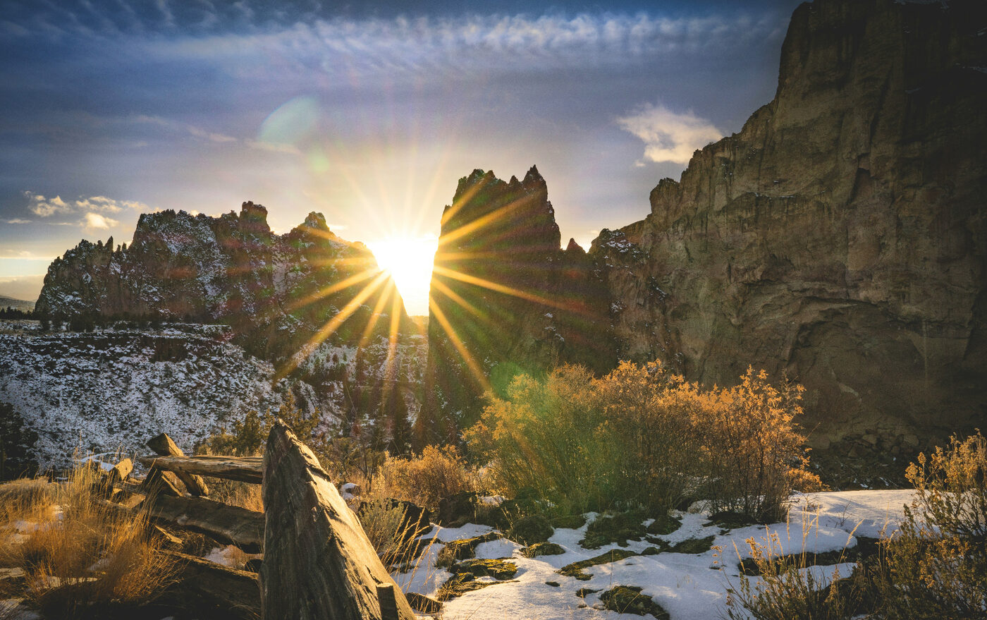 Central Oregon rock formations with sunlight breaking through at sunrise